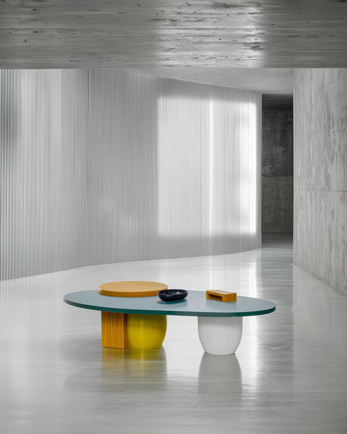 KALEIDOSA center table: an oval teal top with a round oak disc on top, on an oak block, a yellow drum and a white drum