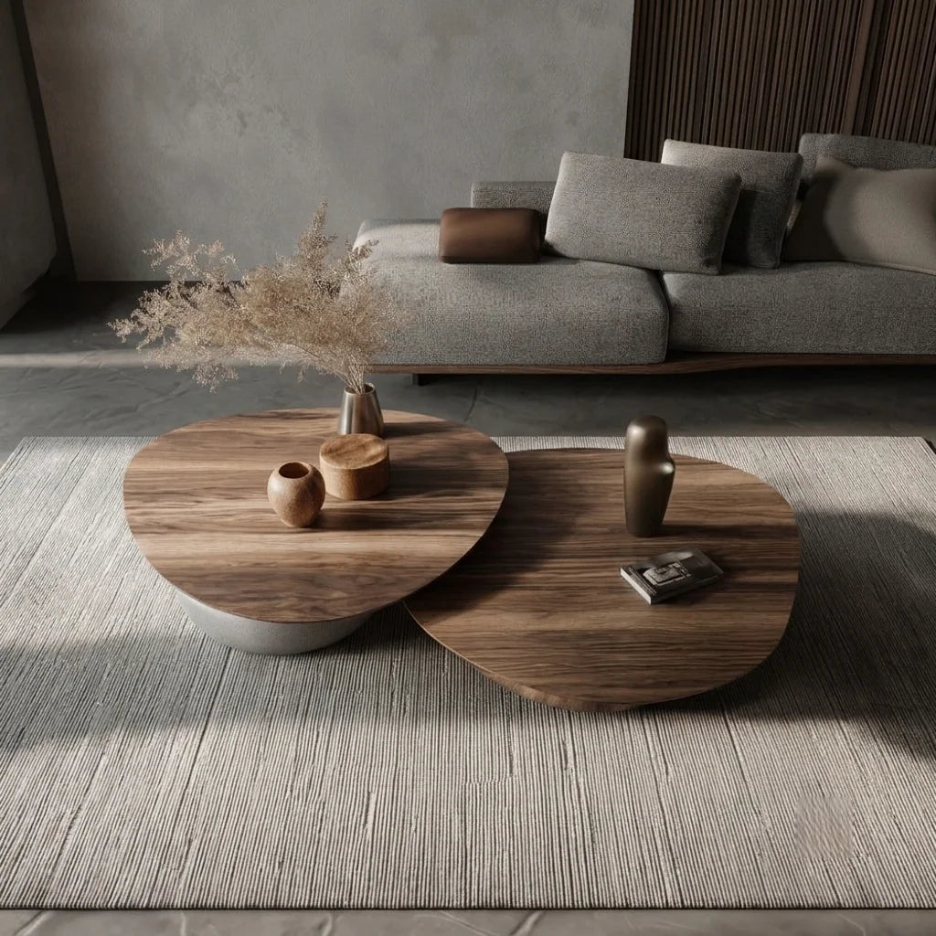KRONE LOCH center table: two pebble-shaped wood tops nested at different heights on a grey rug in front of a grey sofa